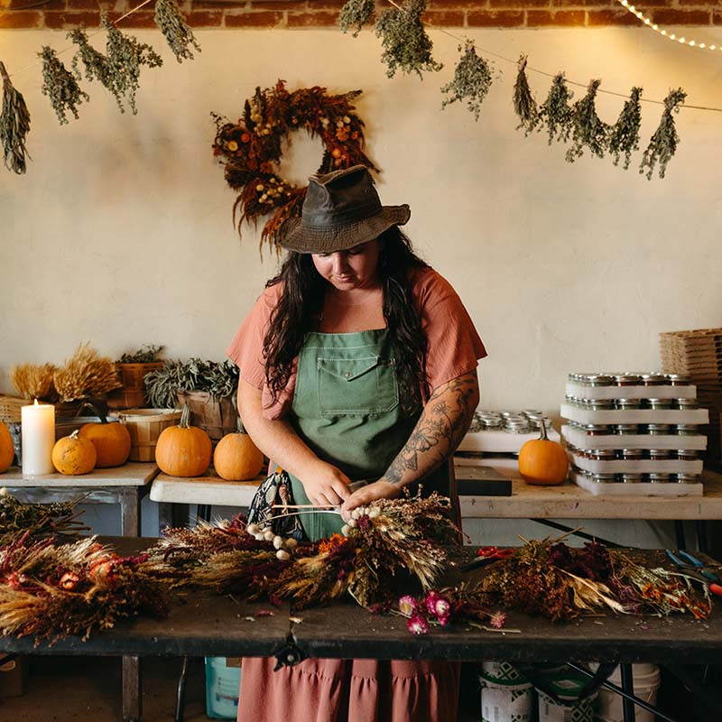 girl handcrafting wreath
