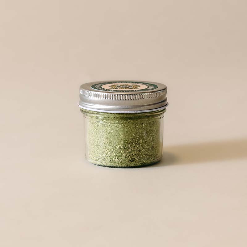 small glass jar of green onion and garlic seasoning blend