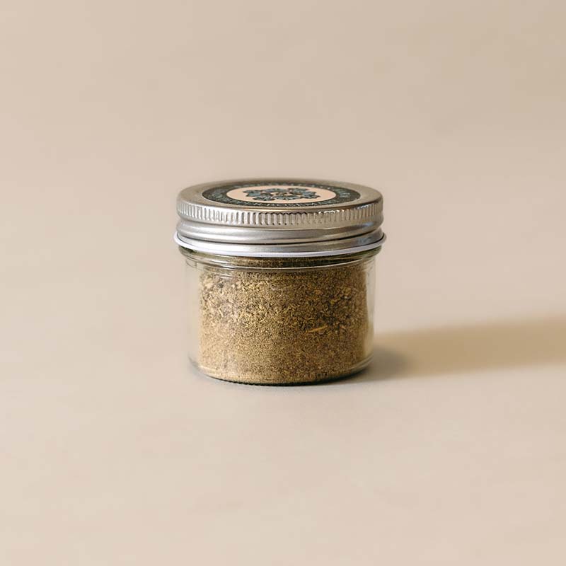 small glass jar of lemon pepper rosemary seasoning blend