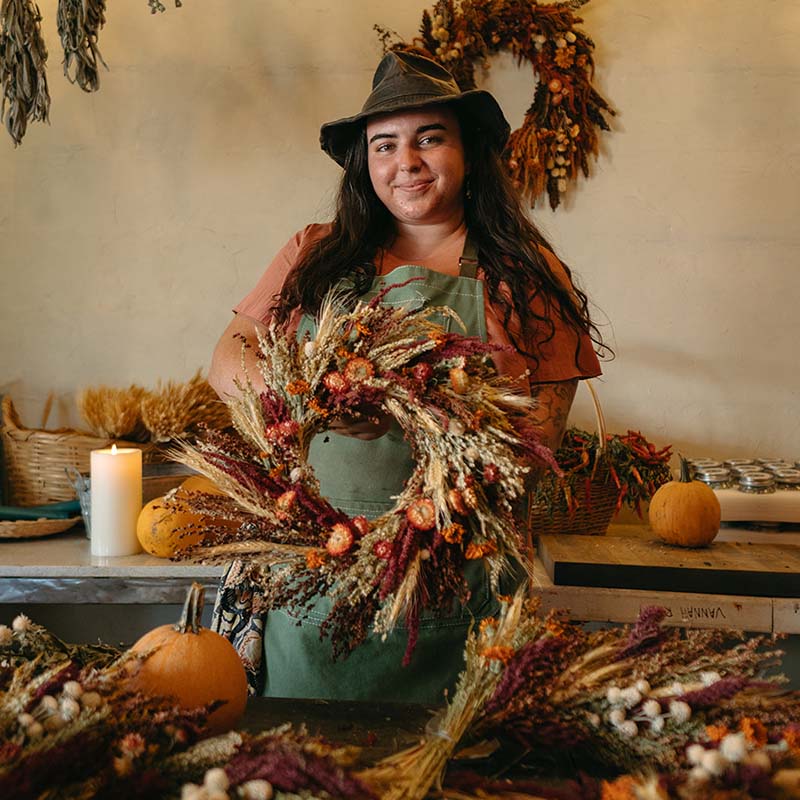 girl holding handcrafted dried flower wreath