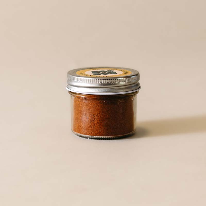 small glass jar of smokey pepper seasoning blend